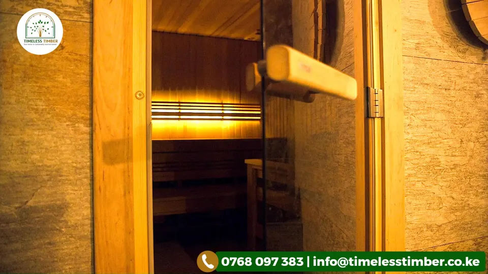 Wooden sauna door and timber-clad wall in warm light, with a Timeless Timber contact banner