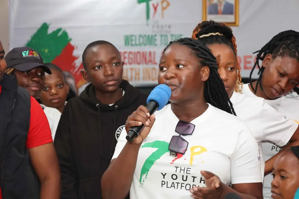 Young woman speaking into a microphone at a Youth Platform forum