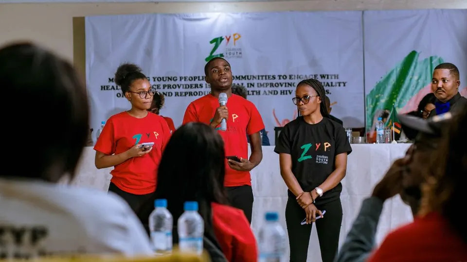 The Youth Platform team speaking on stage at a youth health forum
